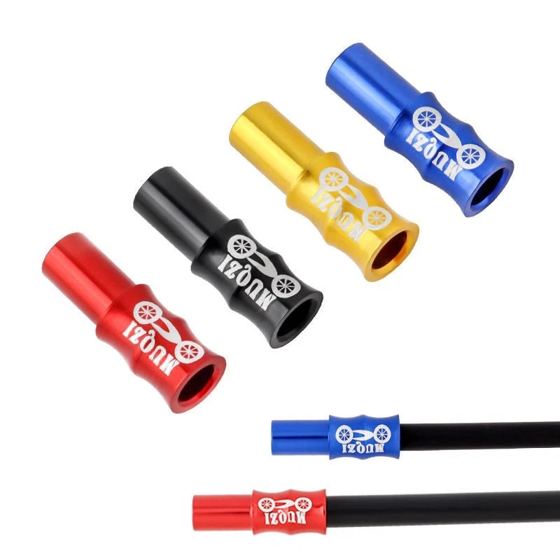 Cable end caps in red, black, gold and blue, two of them fitted to outer cable