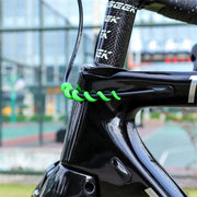 Green spiral cable protector fitted to the head tube of a black road bike