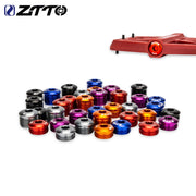 Alloy M14 pedal end caps in a range of colours, with one fitted to a red pedal