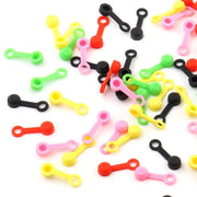 A scattered pile of silicone bleed nipple covers in five colours