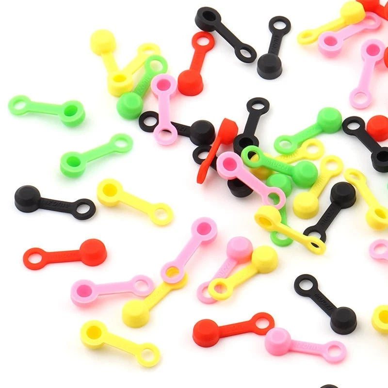 A scattered pile of silicone bleed nipple covers in five colours