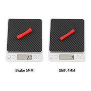 Brake 5mm and shift 4mm cable protectors weighed on digital scales
