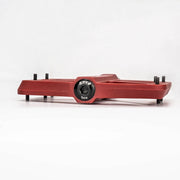 Red flat pedal with an alloy end cap fitted to the axle
