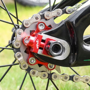 Red chain tensioner fitted at the rear dropout of a single speed bike
