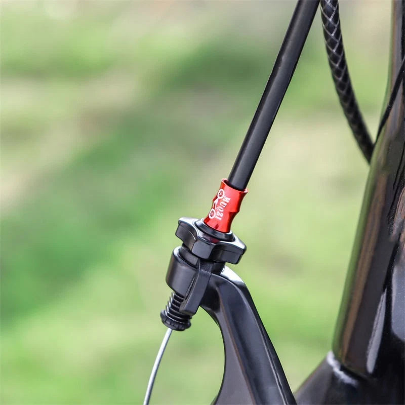 Red alloy cable end cap fitted where the cable enters the frame