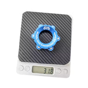 Blue Centrelock to 6 bolt adapter weighed on scales at 31.8 grams