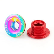 Rainbow and red crank bolt caps, one turned to show the thread