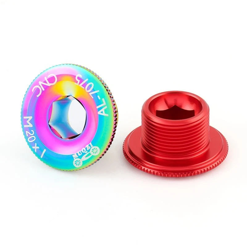 Rainbow and red crank bolt caps, one turned to show the thread