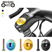 Gold faceted top cap fitted to the stem of a road bike